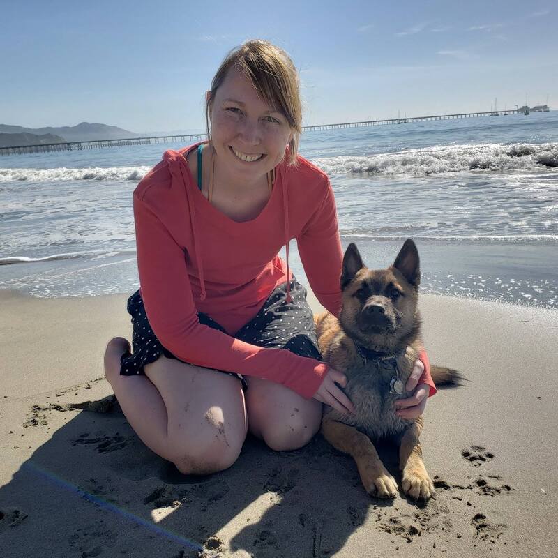 Dr. Aubrie Adams with her dog at the beach